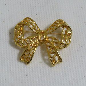 Gold tone filigree bow brooch